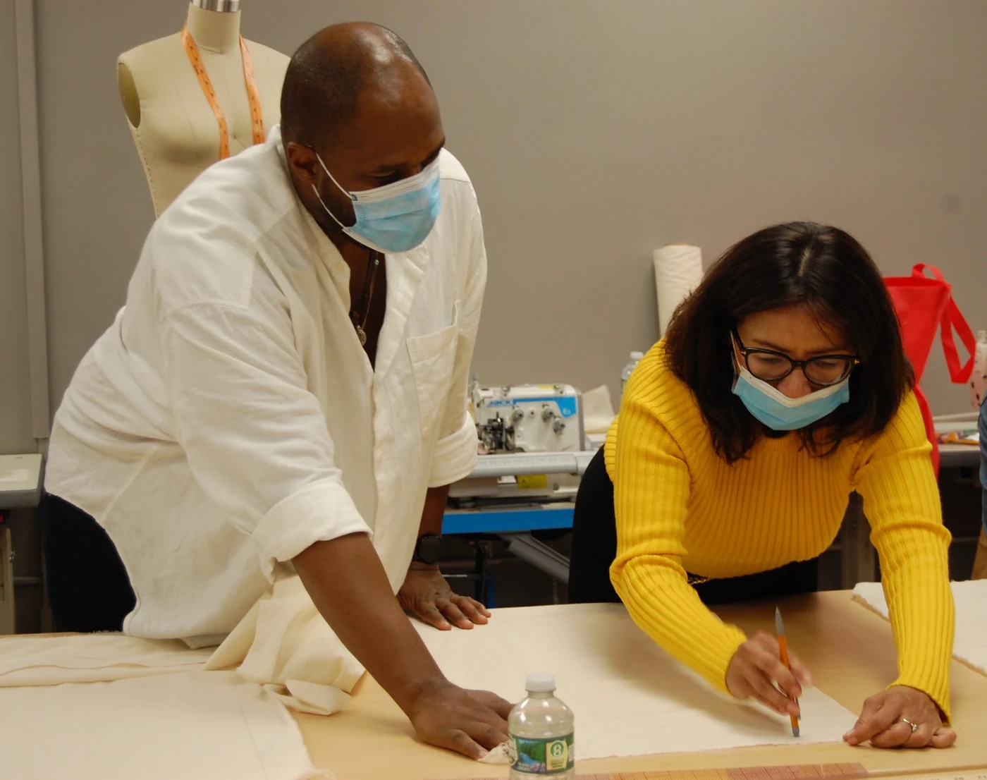 A workshop instructor and participant working together